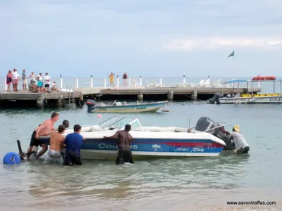 Aaron Traffas helps the locals push the ski boat off the trailer